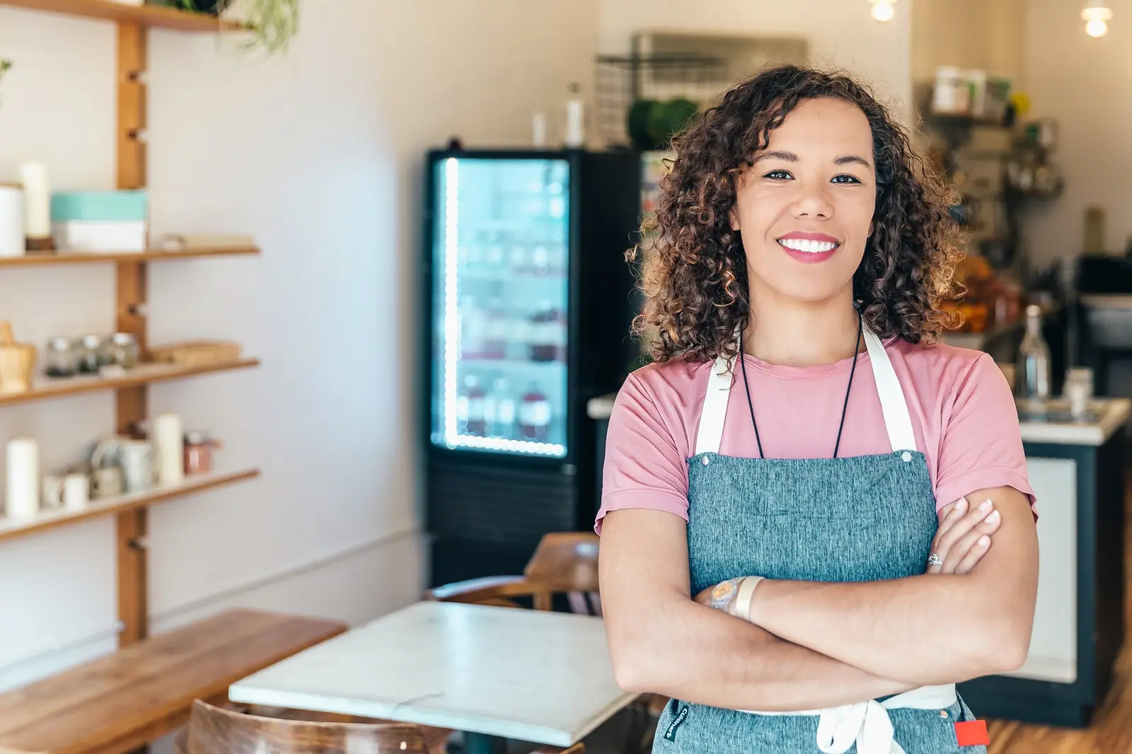 A business owner standing in her shop.