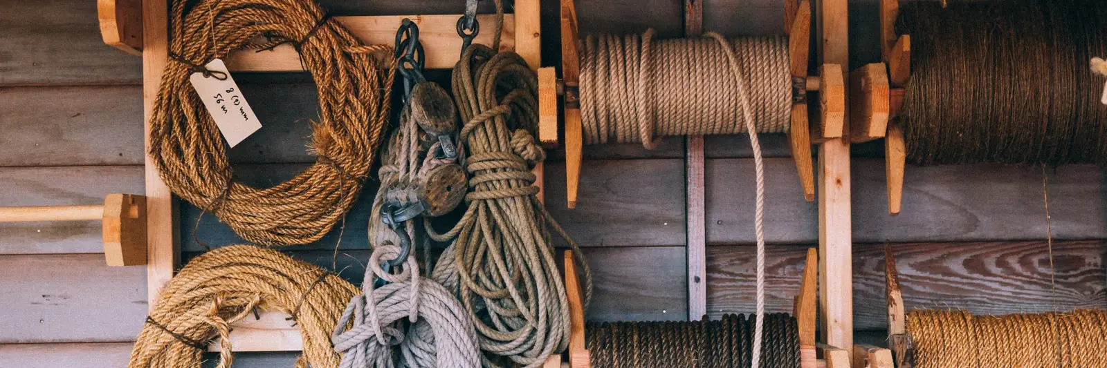 Ropes, yarn and craft materials on a workshop wall.